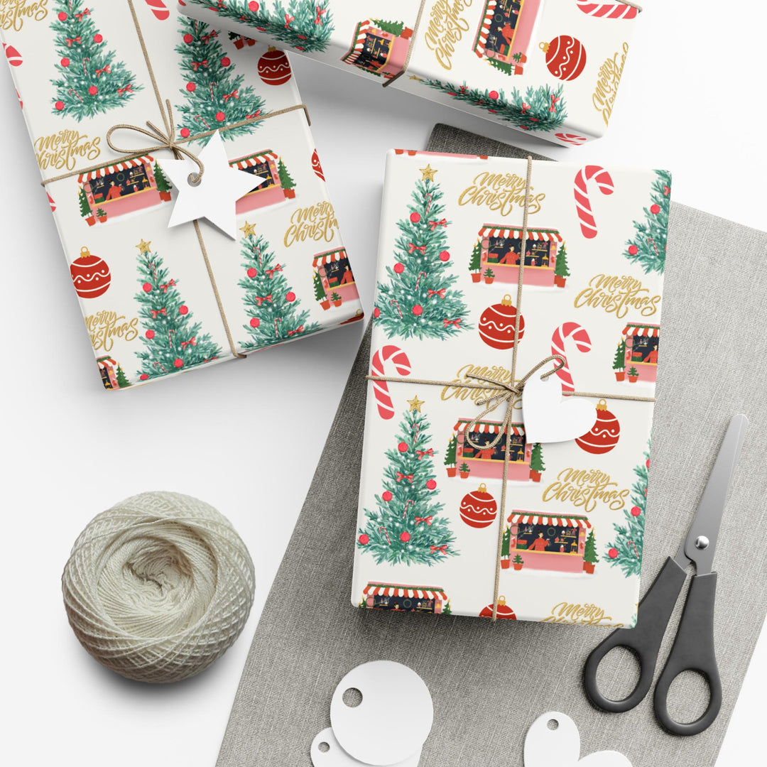 Christmas themed wrapping paper with watercolor graphics of a candy cane, Christmas shop, ornaments and a Christmas tree that has red ornaments. can be printed on a shiny or a matte paper and comes in 3 sizes