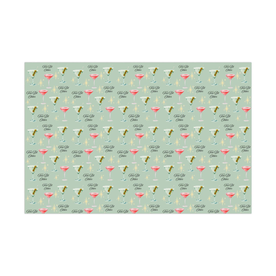 Green wrapping paper with martini glasses and Tini Bit Older text