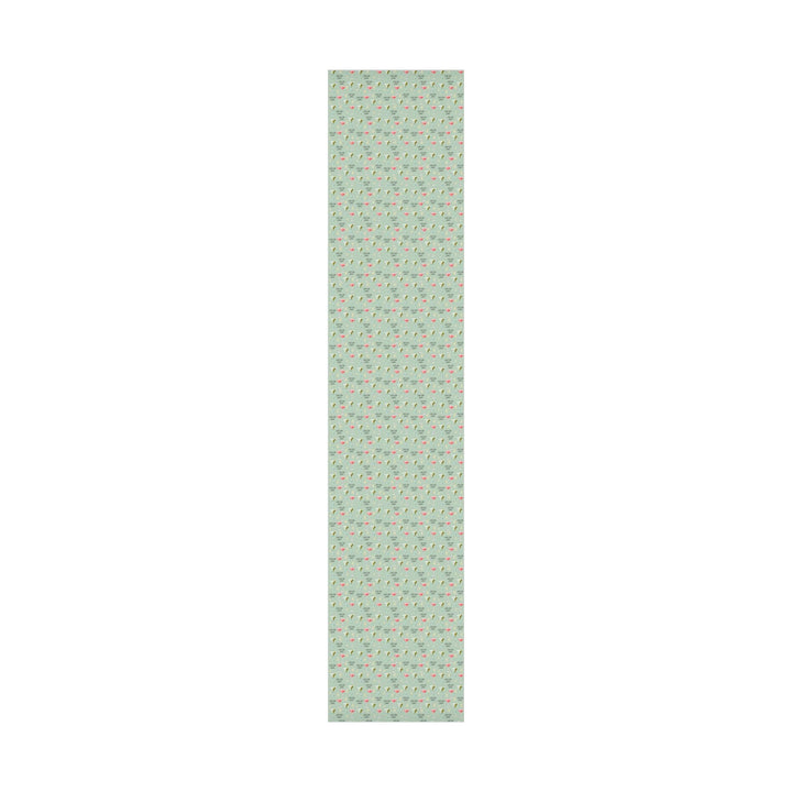 Green wrapping paper with martini glasses and Tini Bit Older text