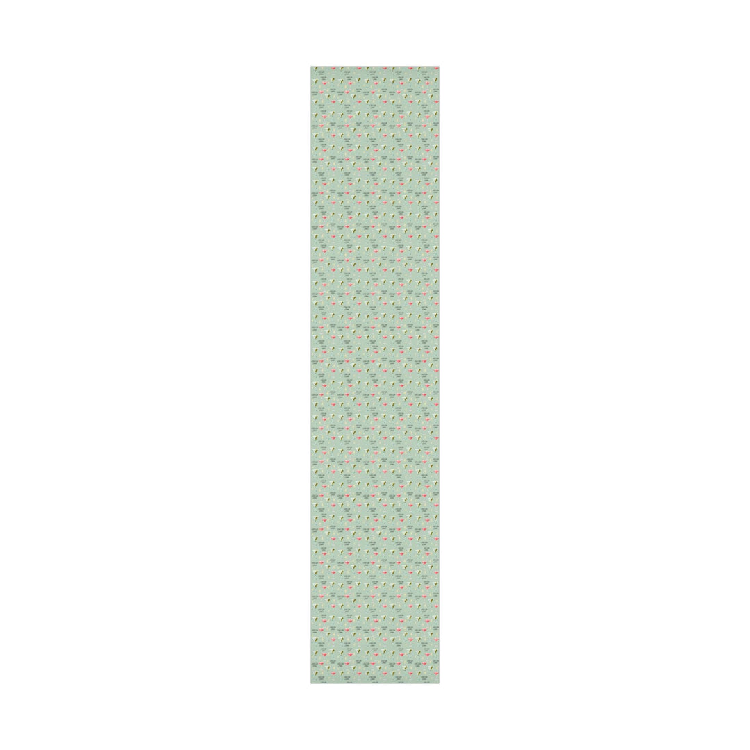 Green wrapping paper with martini glasses and Tini Bit Older text