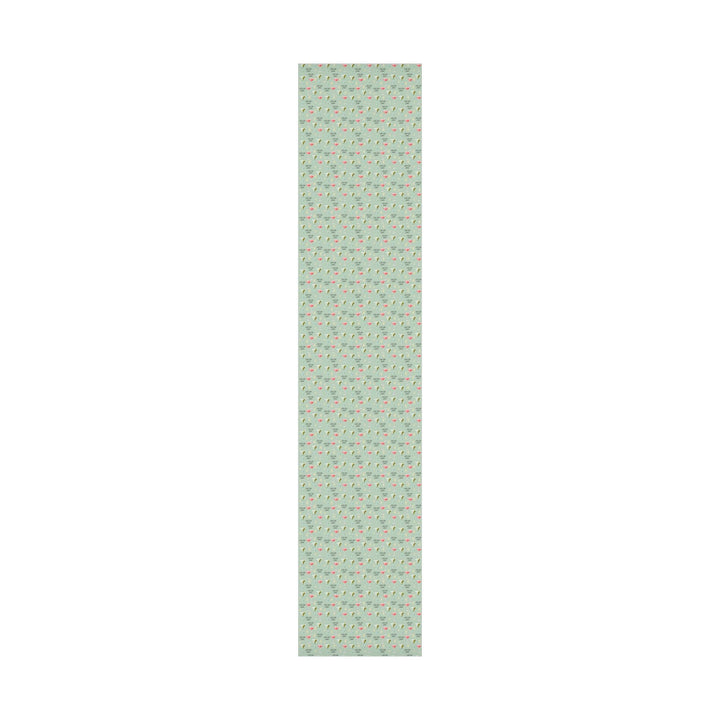 Green wrapping paper with martini glasses and Tini Bit Older text