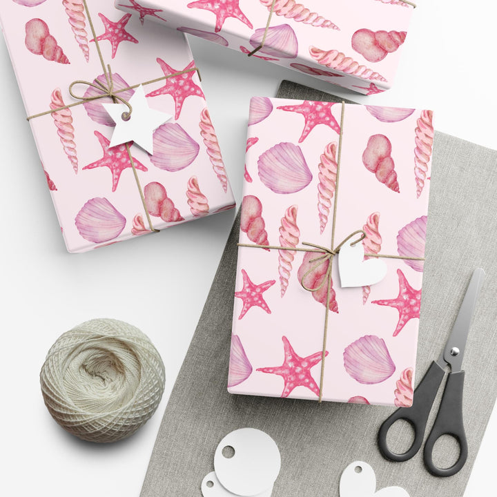 Pink wrapping paper with pink seashell pattern, different seashell shapes in fun bright pink colors