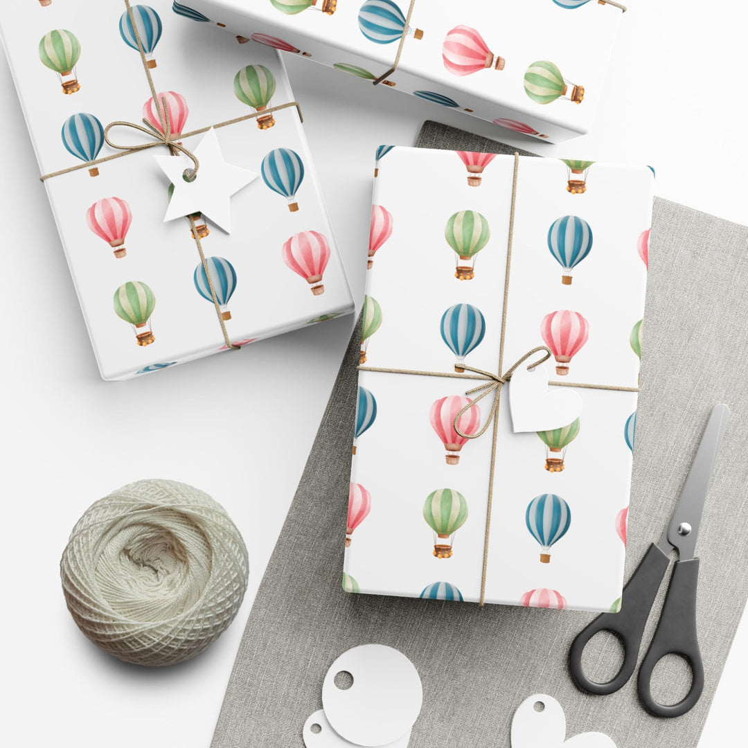 White wrapping paper with cute graphics of hot air balloons in different colors- green blue and pink !