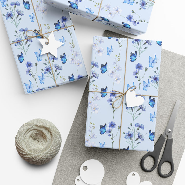 Light pastel blue wrapping paper with graphics of purple lilac flowers and blue butterflies