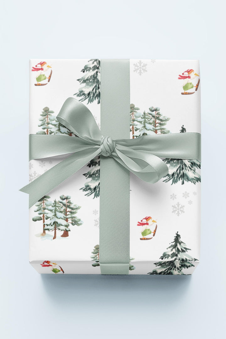 Wrapping paper with Off white background and a ski landscape of trees with a duck in a christmas Santa hat skiing