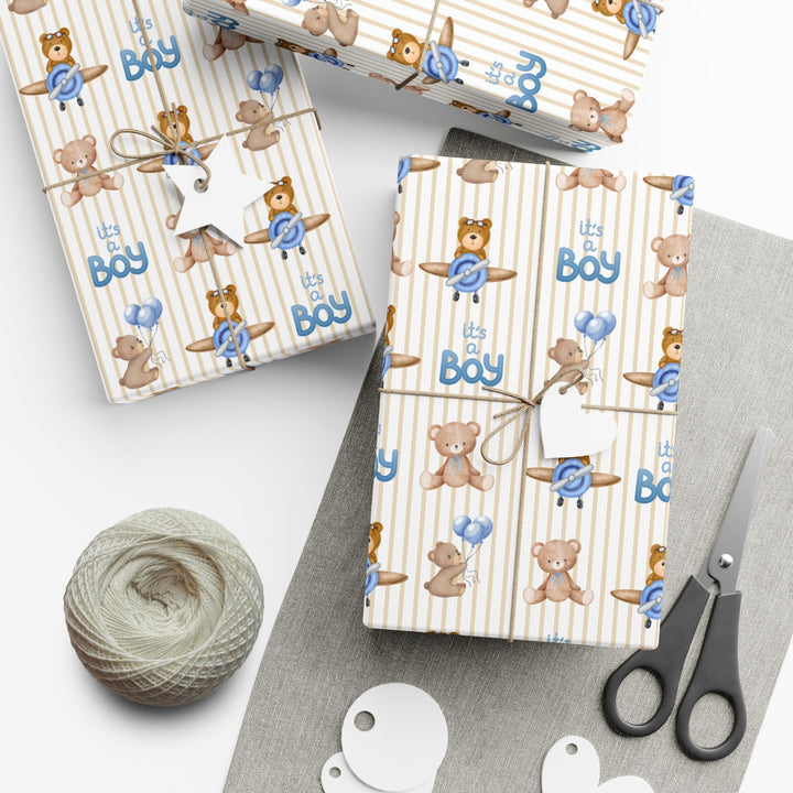 Beige striped wrapping paper with Its a boy text and graphics of little brown bears with blue balloons