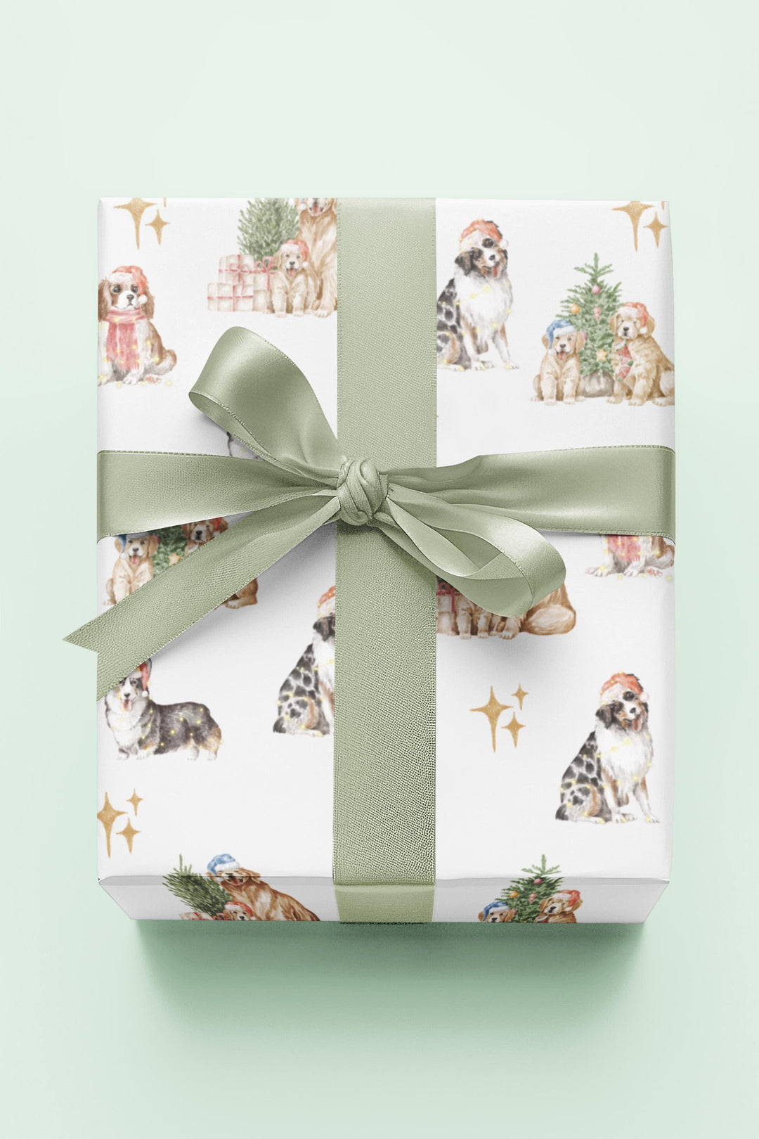 wrapping paper with white background and several different christmas dog graphics, cavalier, golden retriever, shepherd