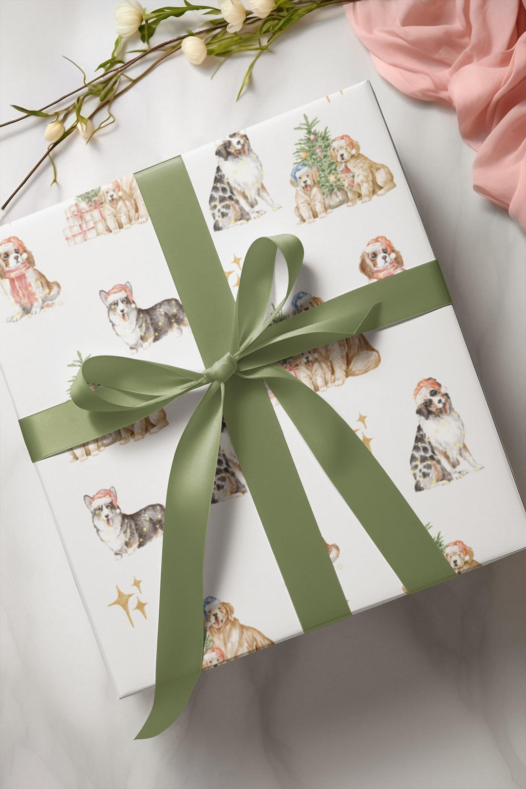 wrapping paper with white background and several different christmas dog graphics, cavalier, golden retriever, shepherd