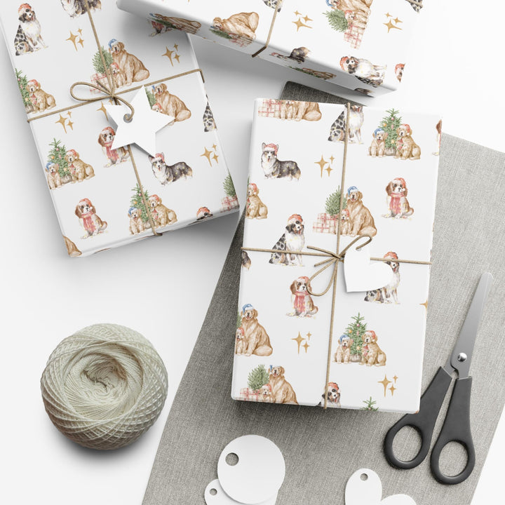 wrapping paper with white background and several different christmas dog graphics, cavalier, golden retriever, shepherd