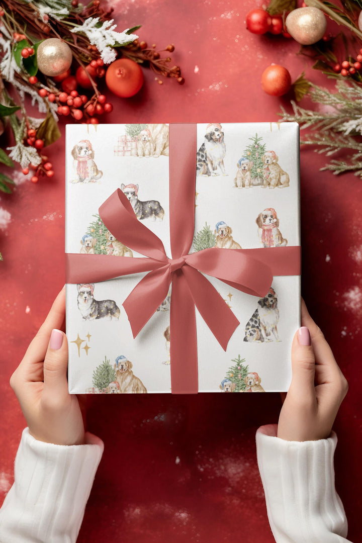 wrapping paper with white background and several different christmas dog graphics, cavalier, golden retriever, shepherd