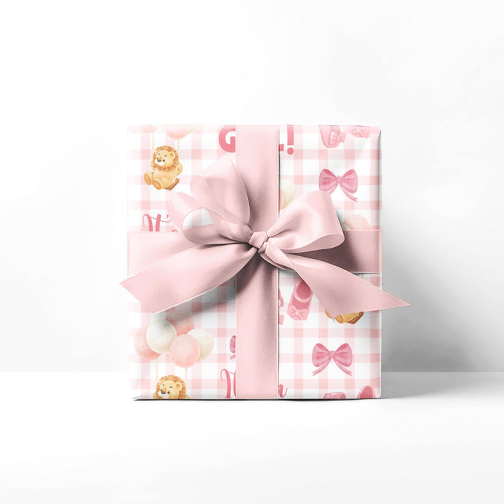 Pink gingham wrapping paper with graphics of lion with balloons, baby ballet flats, baby pink bow and It&#39;s a Girl text