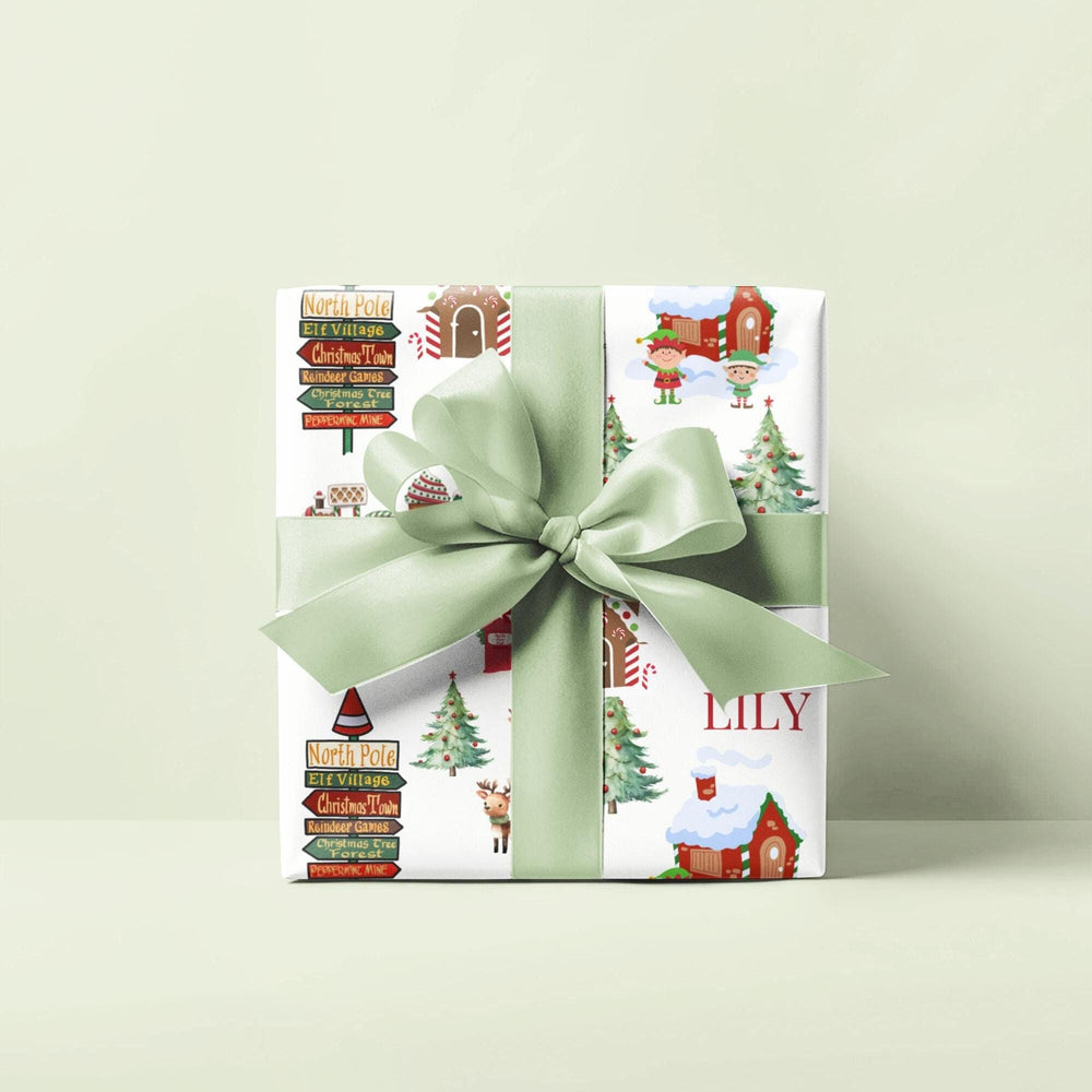 North Pole themed wrapping paper with graphics of elf village, peppermint house , North Pole signs, christmas trees and reindeers, candy cane village, christmas tree forest, peppermint mine personalized with a name