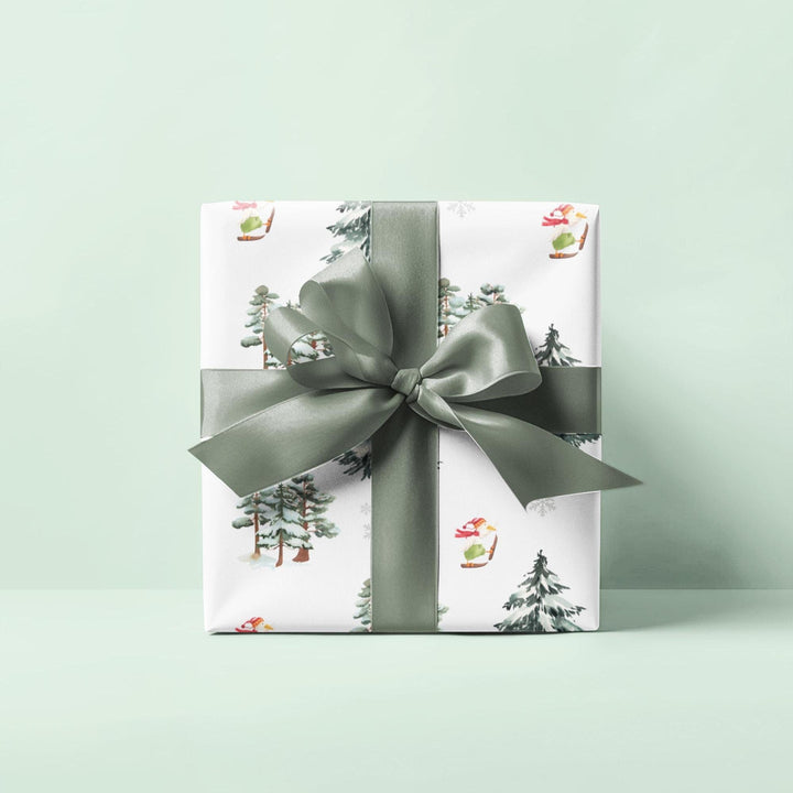 Wrapping paper with Off white background and a ski landscape of trees with a duck in a christmas Santa hat skiing