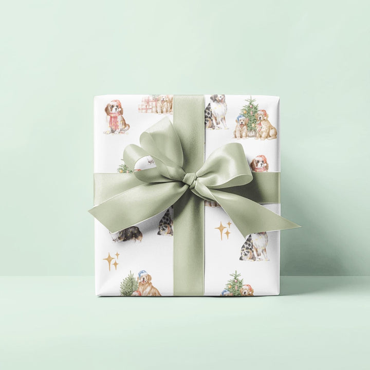 wrapping paper with white background and several different christmas dog graphics, cavalier, golden retriever, shepherd