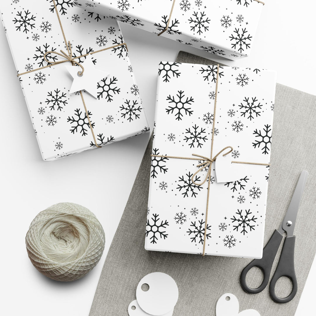 wrapping paper with white background and black snowflakes all over in a subtle but minimal look! beautiful and elegant black and white look!