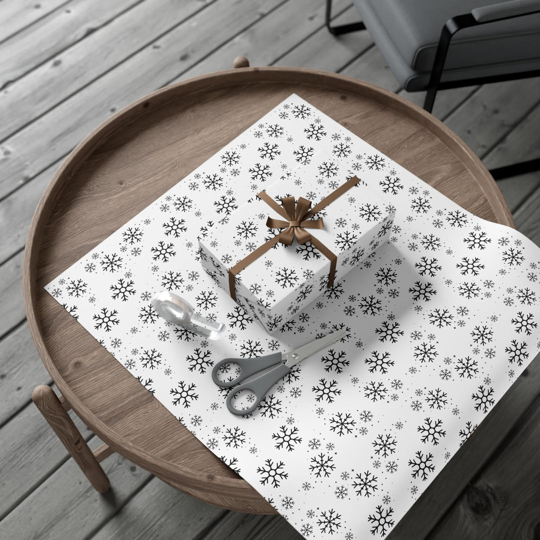 wrapping paper with white background and black snowflakes all over in a subtle but minimal look! beautiful and elegant black and white look!