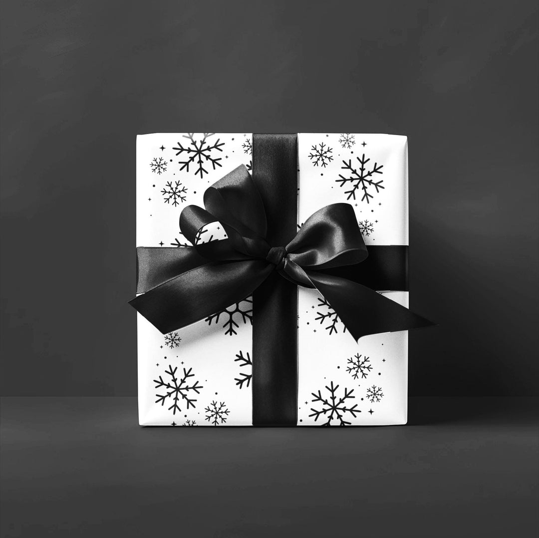 wrapping paper with white background and black snowflakes all over in a subtle but minimal look! beautiful and elegant black and white look!