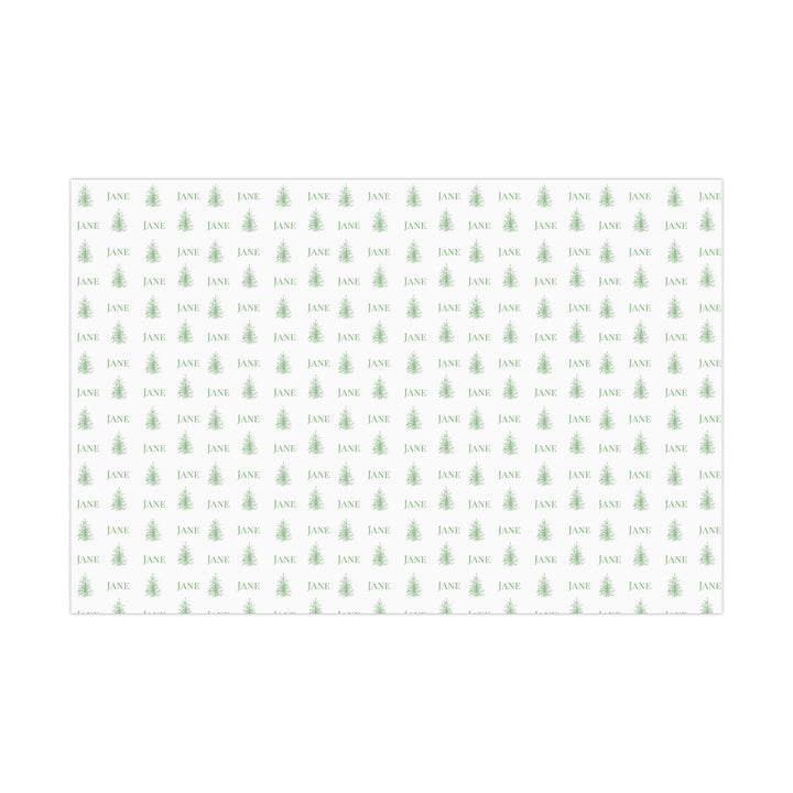 white background with elegant green christmas trees and display font of a personalized name on wrapping paper