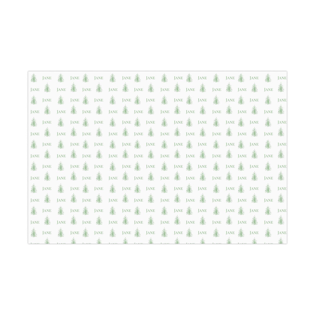 white background with elegant green christmas trees and display font of a personalized name on wrapping paper