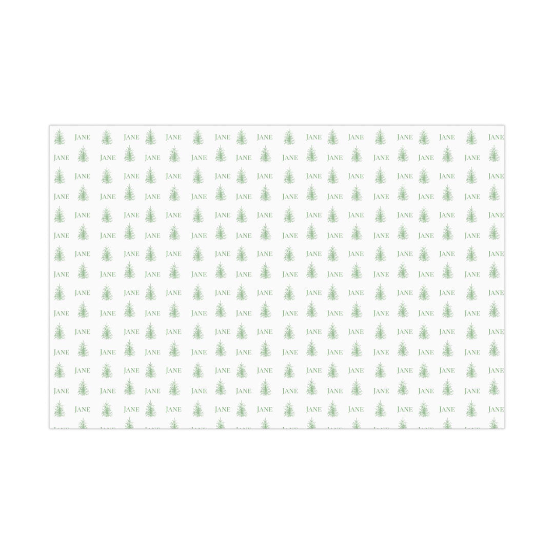 white background with elegant green christmas trees and display font of a personalized name on wrapping paper