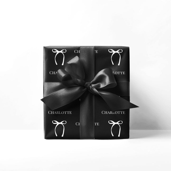 black wrapping paper with white bows and personalized name! chic and trendy gift wrap