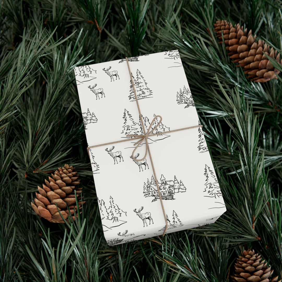 off white background with black silhouettes of christmas trees and  town and christmas log cabin with reindeer graphics- elegant and understated but beautiful and classic