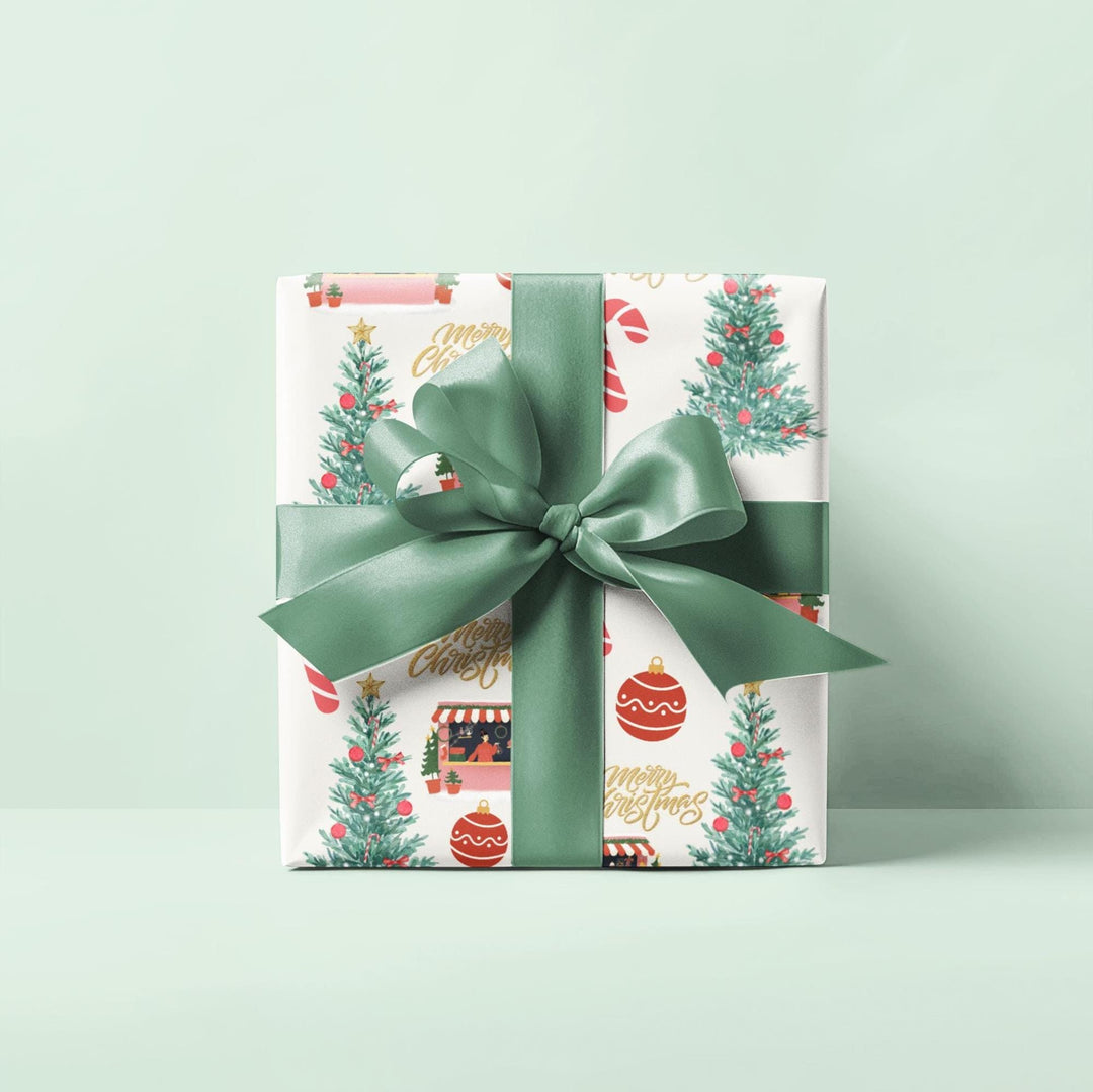 Christmas themed wrapping paper with watercolor graphics of a candy cane, Christmas shop, ornaments and a Christmas tree that has red ornaments. can be printed on a shiny or a matte paper and comes in 3 sizes