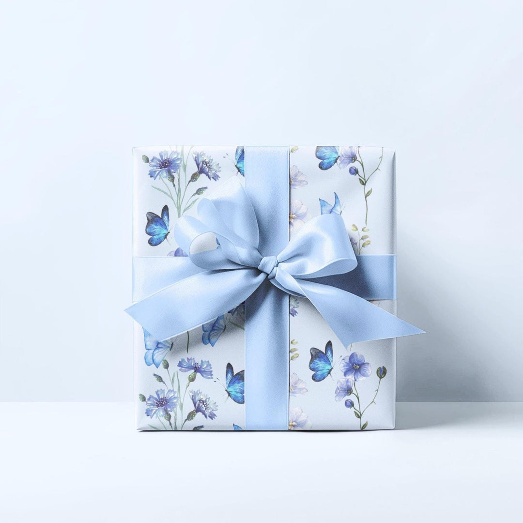 Light pastel blue wrapping paper with graphics of purple lilac flowers and blue butterflies