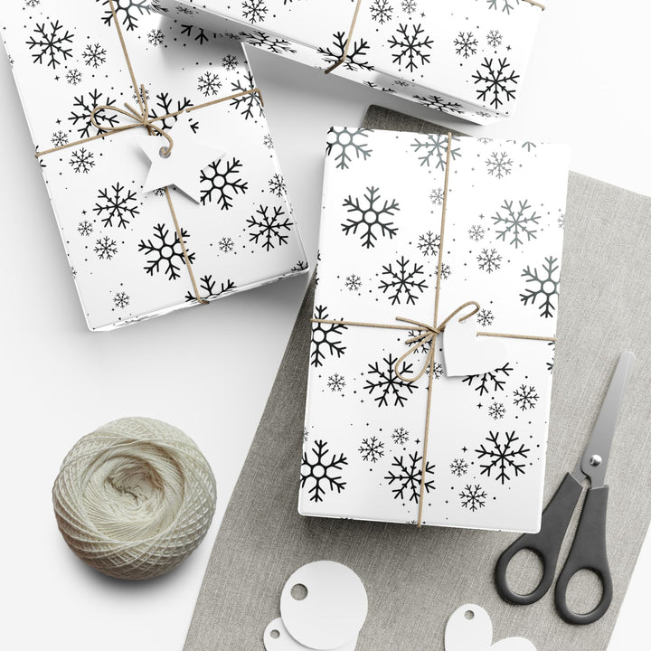 wrapping paper with white background and black snowflakes all over in a subtle but minimal look! beautiful and elegant black and white look!