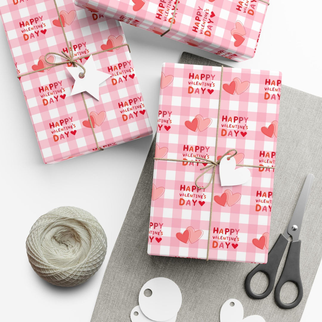 Happy valentines day wrapping paper on pink gingham bHappy valentines day wrapping paper on pink gingham background with pink hearts ackground with pink hearts