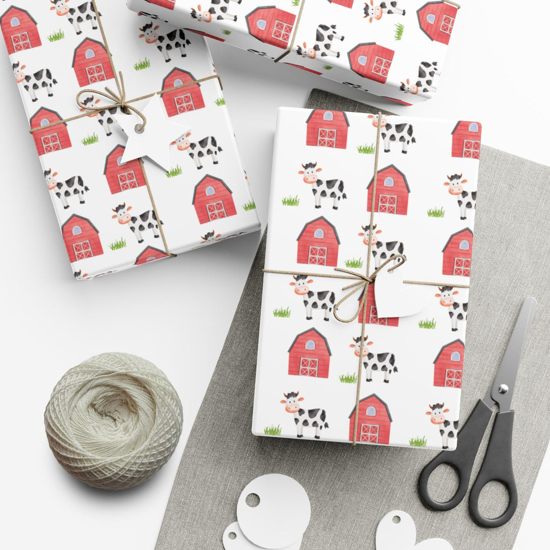 Cow theme wrapping paper with farmhouse and grass graphics on white wrapping paper